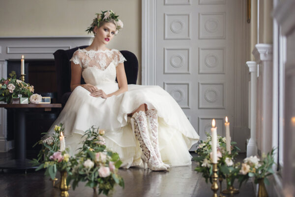 Bride wearing Beatrice Elliot Ivory lace wedding boots with flower crown