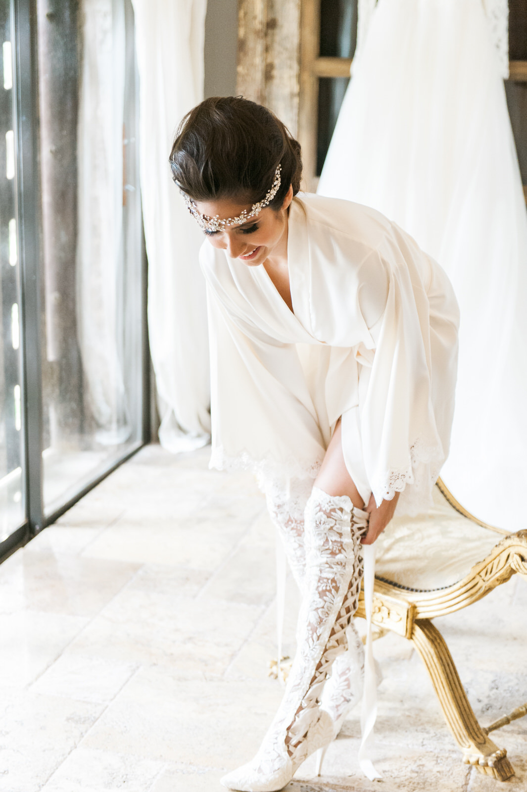 Bride Getting Ready and putting on her House of Elliot over the knee lace bridal boots