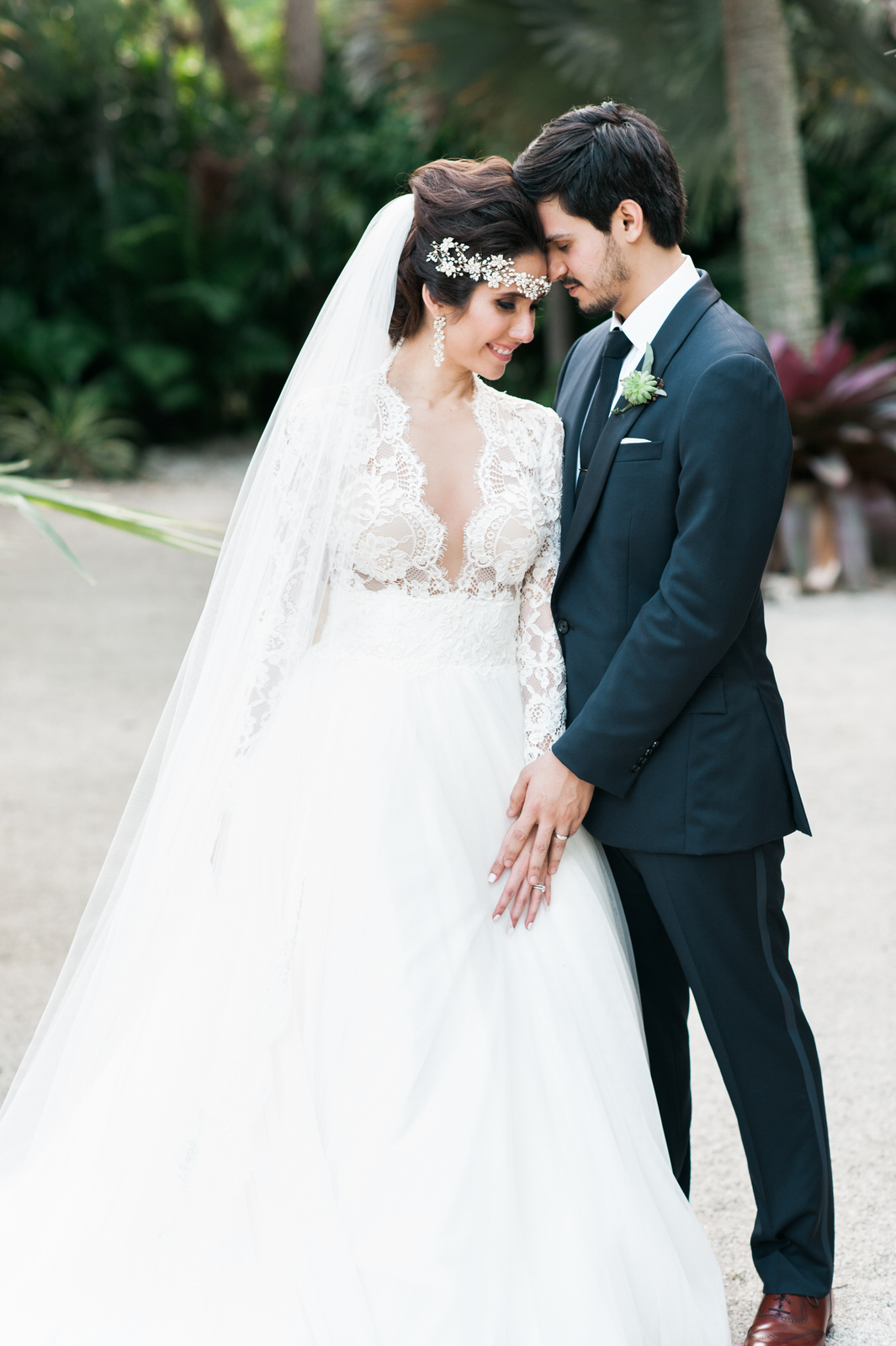 Bride wearing long sleeved princess lace dress