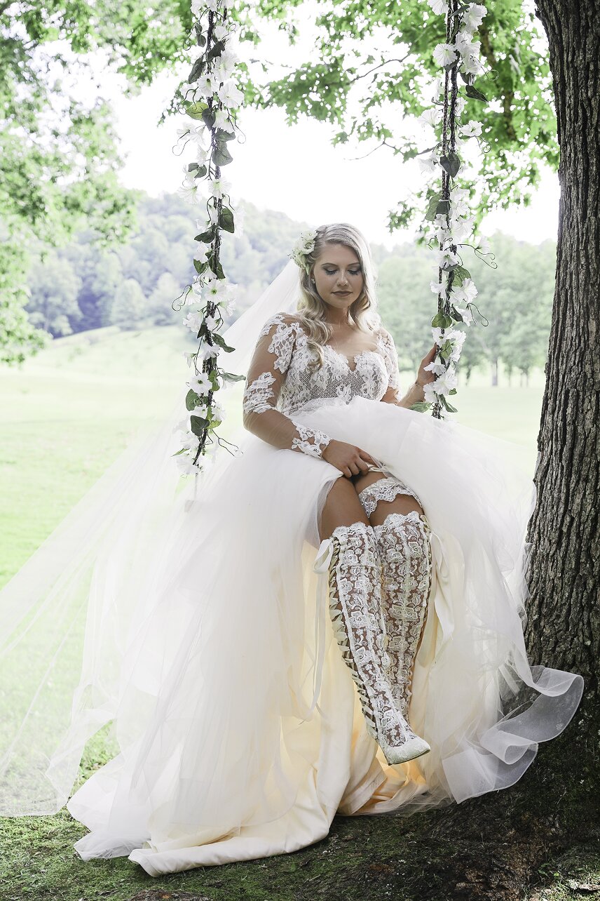 Real Bride Lauren wearing Hailey Page Pippa Gown paired with House of Elliot' Lace over the knee wedding boots