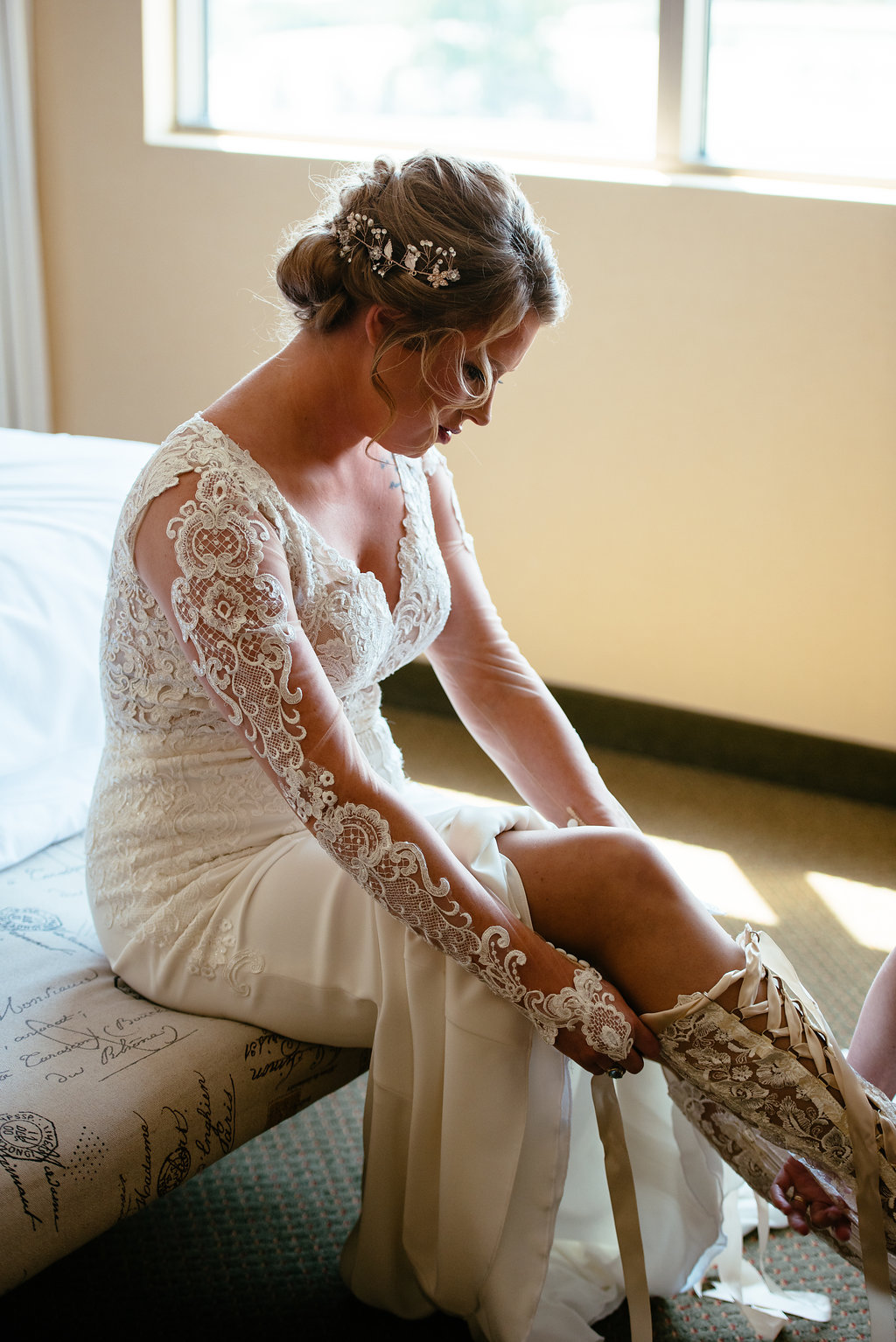 Ivory long sleeved wedding dress with vintage lace bridal boots