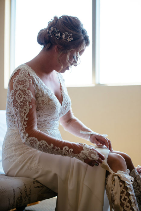 Bride putting on Lace wedding boots getting ready