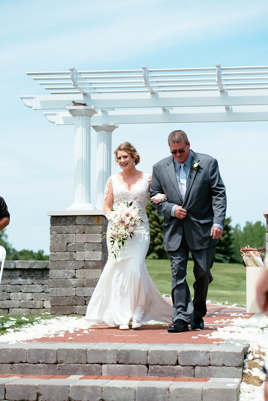 Bride walking down the aisle vintag long sleeved lace dress 