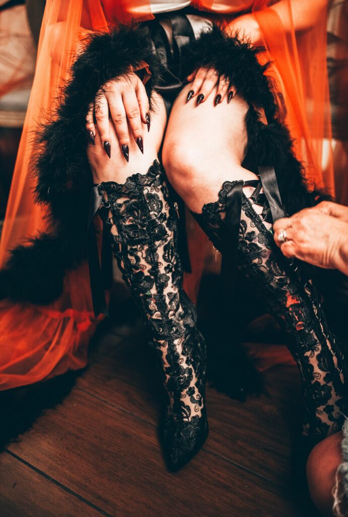 Bride wearing black lace wedding dress and Beatrice Elliot Black Lace Boots in gothic Halloween wedding